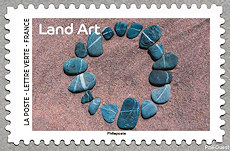 Image du timbre Cercle fait de galets dans le sable